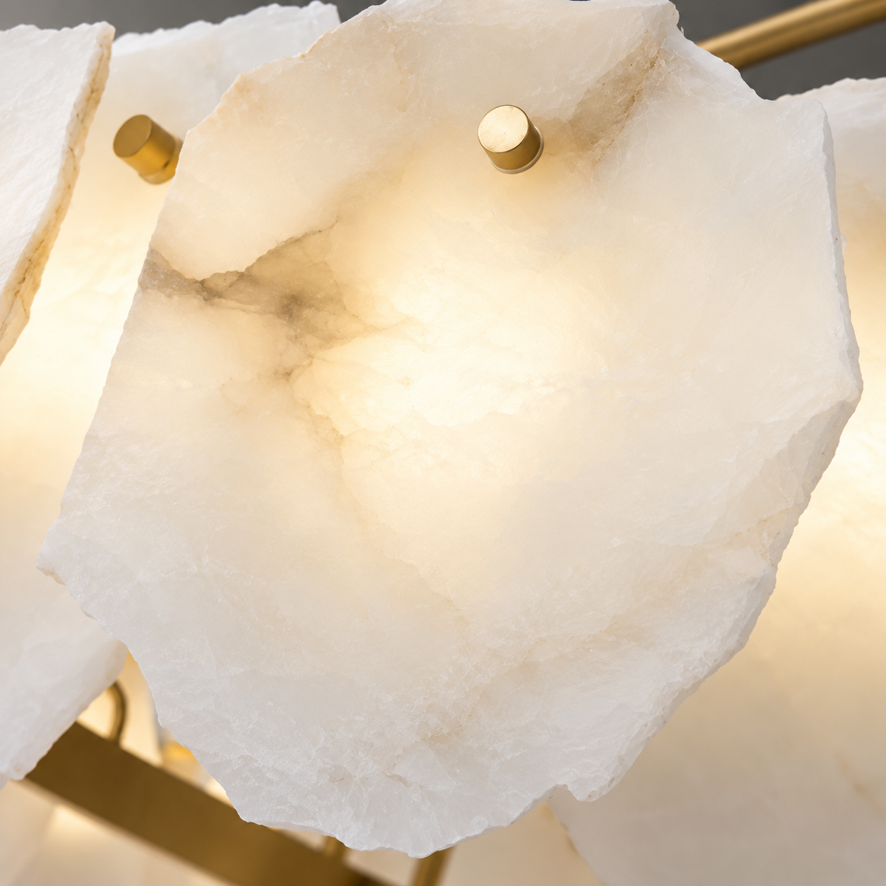 Natural alabaster stone detail with brushed gold mounting hardware